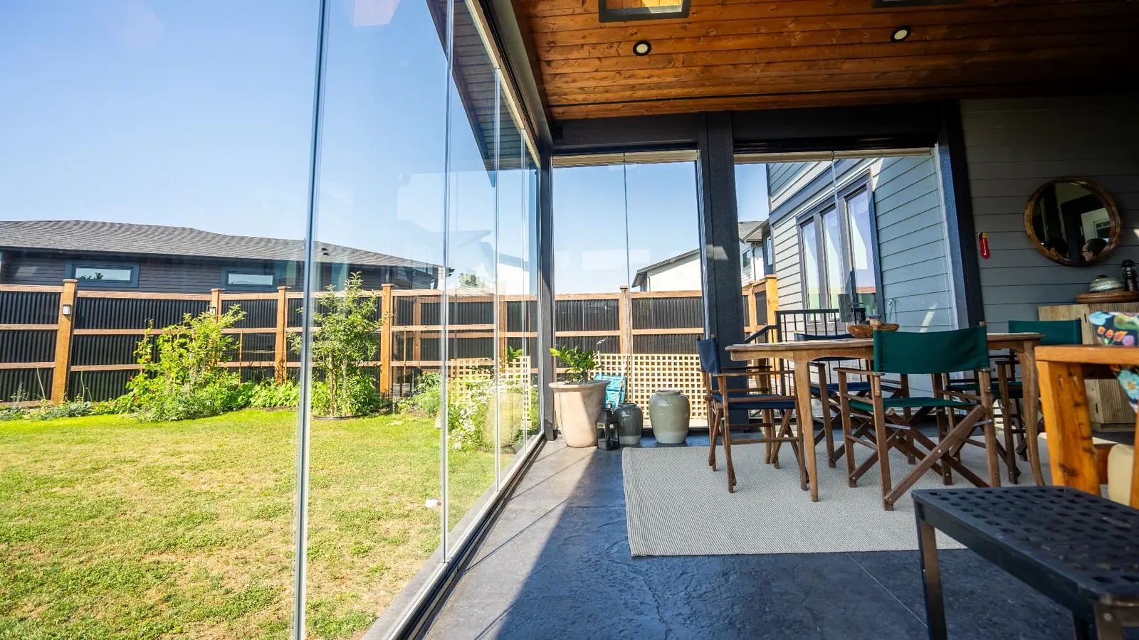 Lumon frameless glass panels enclosing a covered residential patio