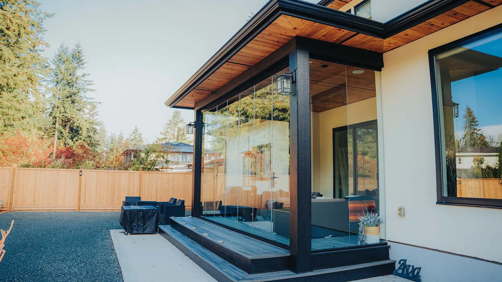 Retractable Lumon glass sliding walls on a covered patio