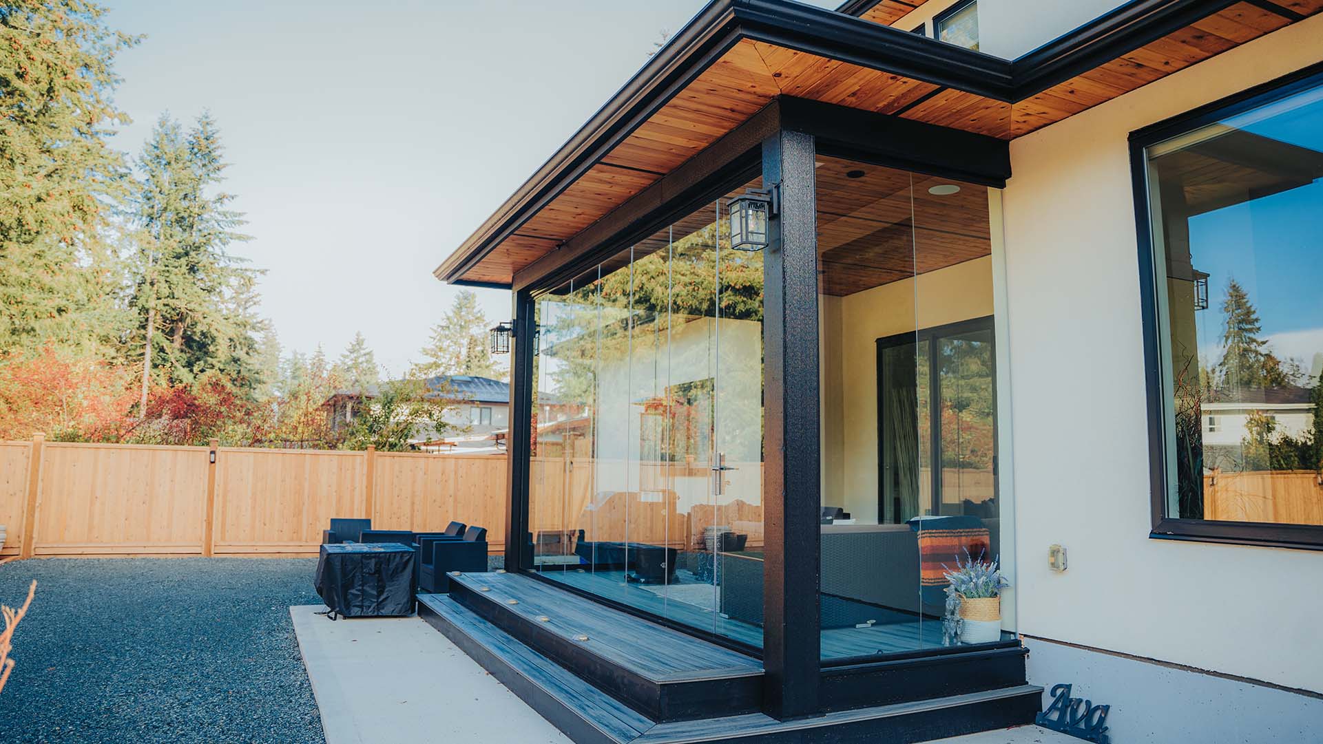 Retractable Lumon glass sliding walls on a covered patio