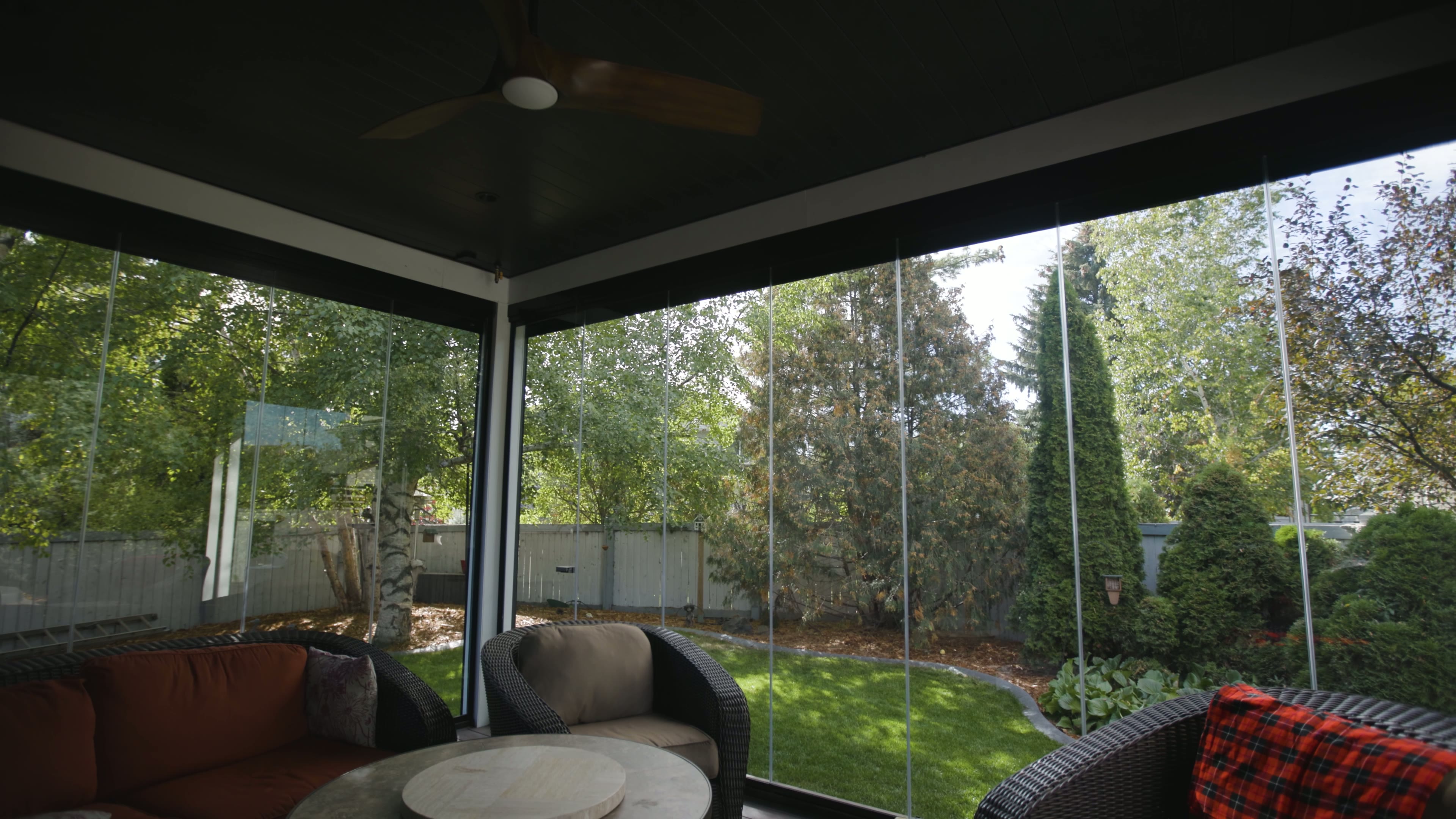 Lumon glass walls integrated into a louvered pergola