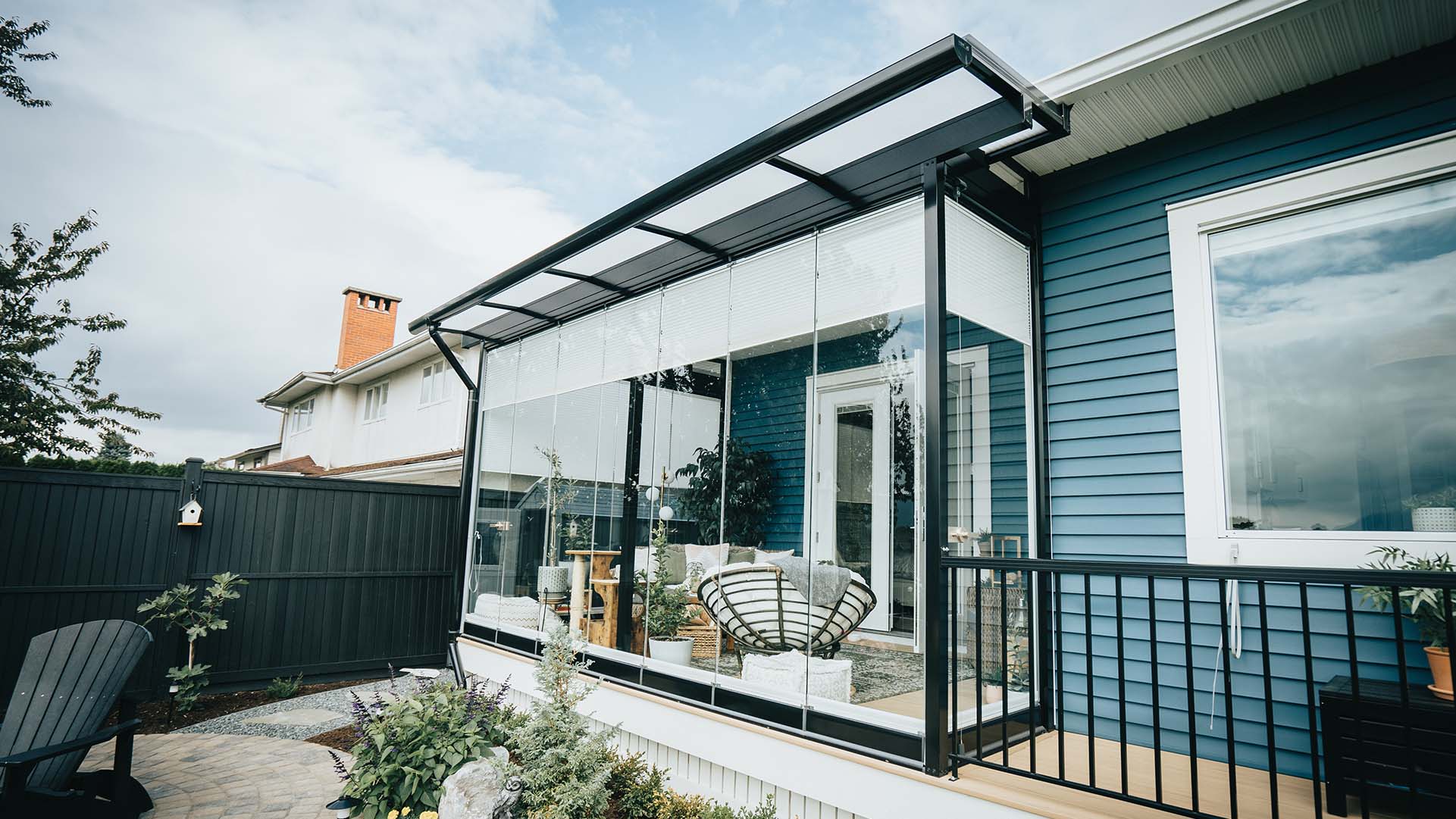 Backyard patio enclosed with Lumon glass used as extra living space