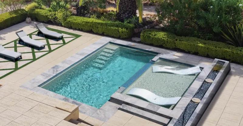 The Chic fiberglass pool design installed in a modern backyard