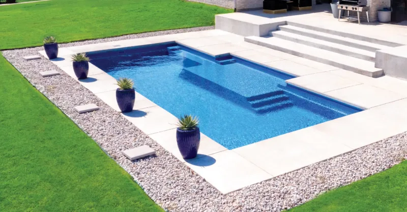 The Dynasty fiberglass pool design installed in a modern backyard