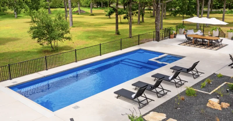 The Intrigue fiberglass pool design installed in a modern backyard