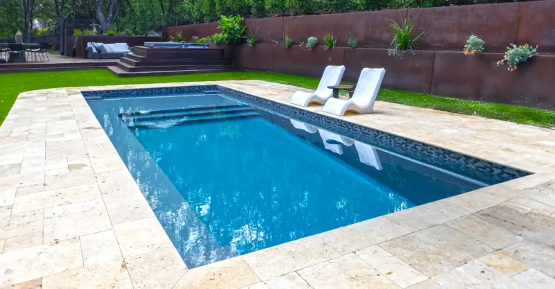 The Ovation fiberglass pool design installed in a modern backyard