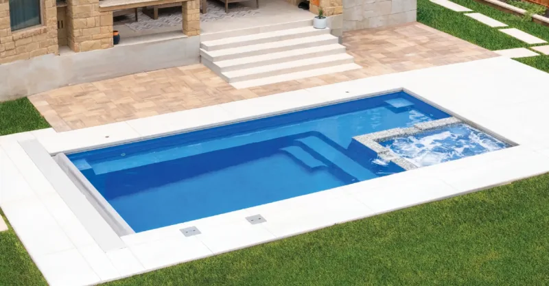 The Triumph fiberglass pool design installed in a modern backyard